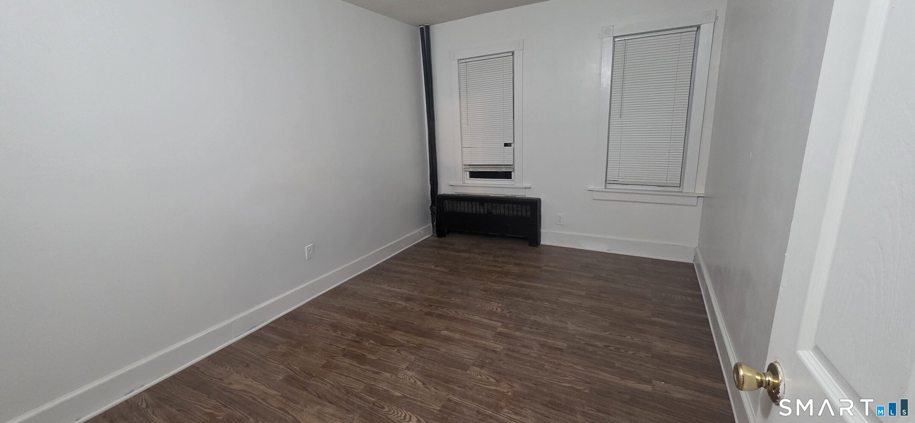 137 Birch Street, Unit 139 Manchester, CT 06040 - Photo 10 of 14 a view of an empty room with wooden floor