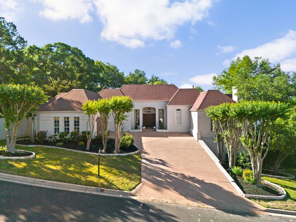 5710 Carry Back Lane Austin, TX 78746 - Photo 1 of 1 a front view of a house with a yard table and chairs