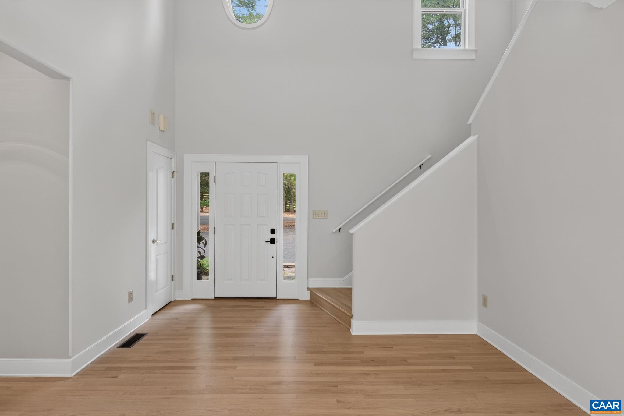 6285 Jarmans Gap Road Crozet, VA 22932 - Photo 11 of 65 a view of an empty room with wooden floor and stairs