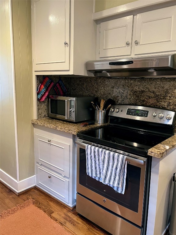 2106 Colquitt Street Houston, TX 77098 - Photo 15 of 31 a kitchen with granite countertop white cabinets and black appliances