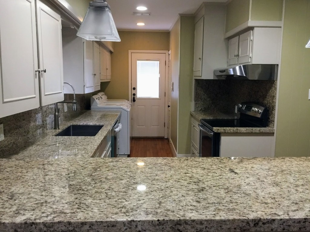 2106 Colquitt Street Houston, TX 77098 - Photo 2 of 31 a kitchen with stainless steel appliances kitchen island granite countertop a sink a stove and a refrigerator