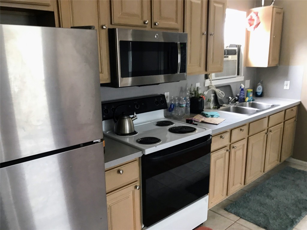2106 Colquitt Street Houston, TX 77098 - Photo 31 of 31 a kitchen with a sink stove and microwave