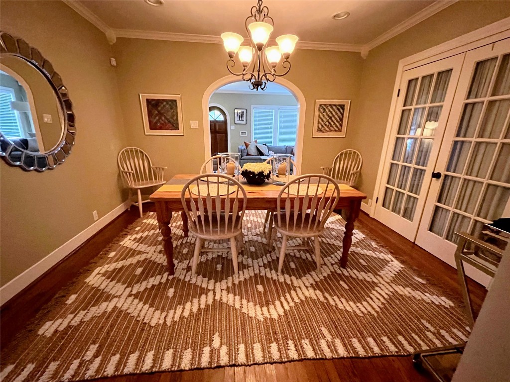 2106 Colquitt Street Houston, TX 77098 - Photo 4 of 31 a view of a dining room with furniture a chandelier and wooden floor