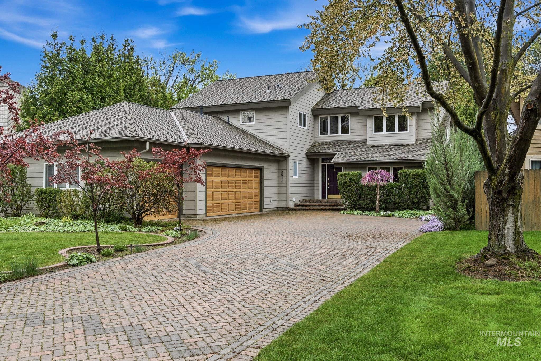 2011 Creekside Lane Boise, ID 83706 - Photo 1 of 1 View of front of house featuring a front lawn, a garage, decorative driveway, and a shingled roof