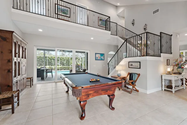 a living room with furniture a chandelier fan and a window