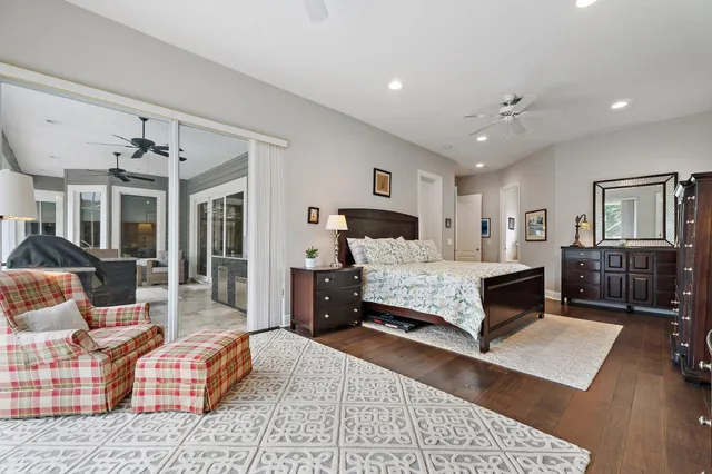 a bathroom with a granite countertop shower sink vanity mirror and toilet