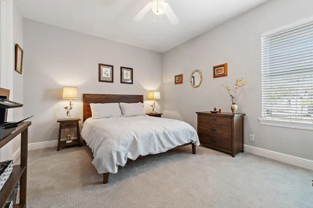 a view of swimming pool with a patio and a garden view