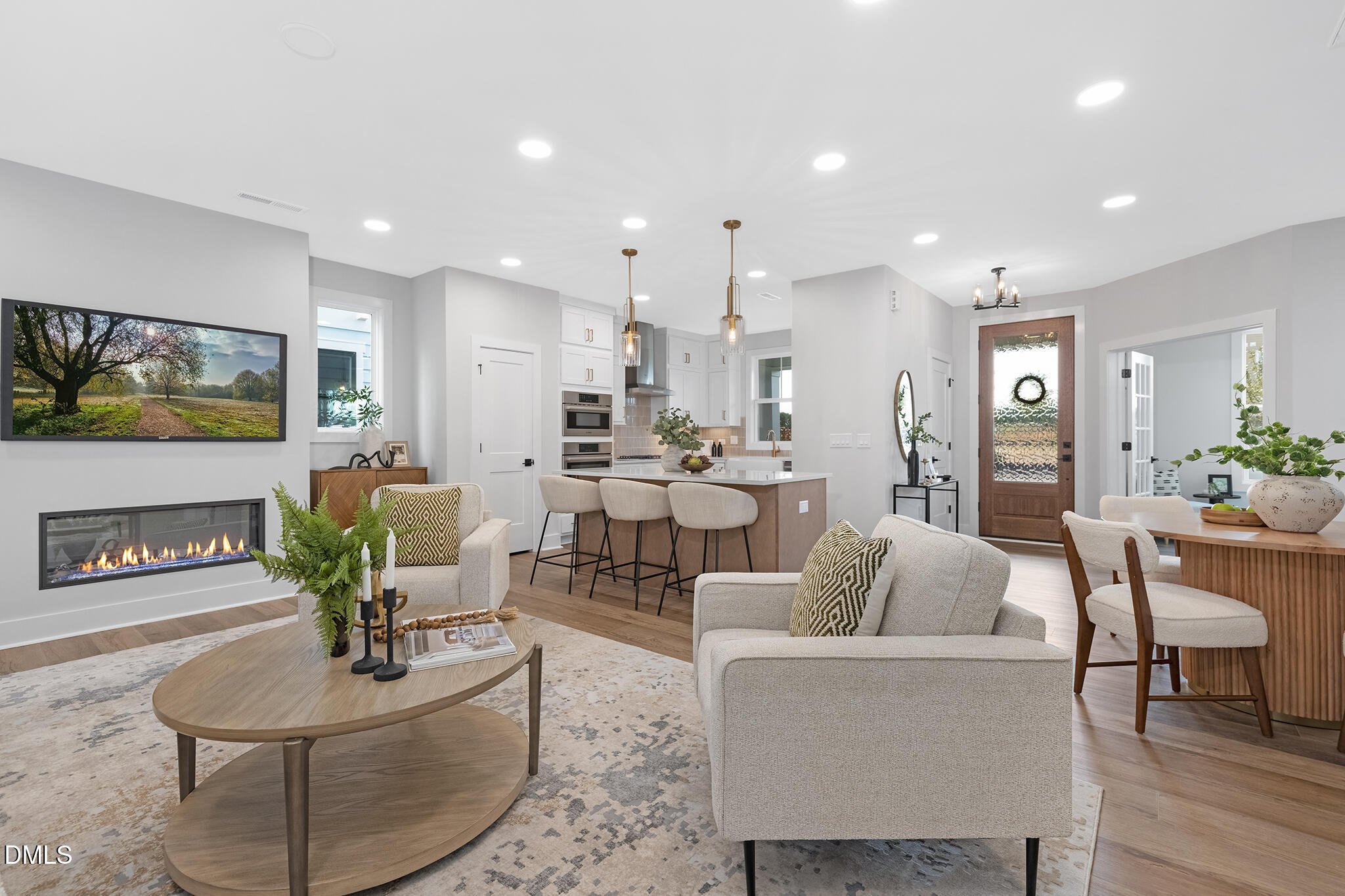 a living room with fireplace furniture and a wooden floor