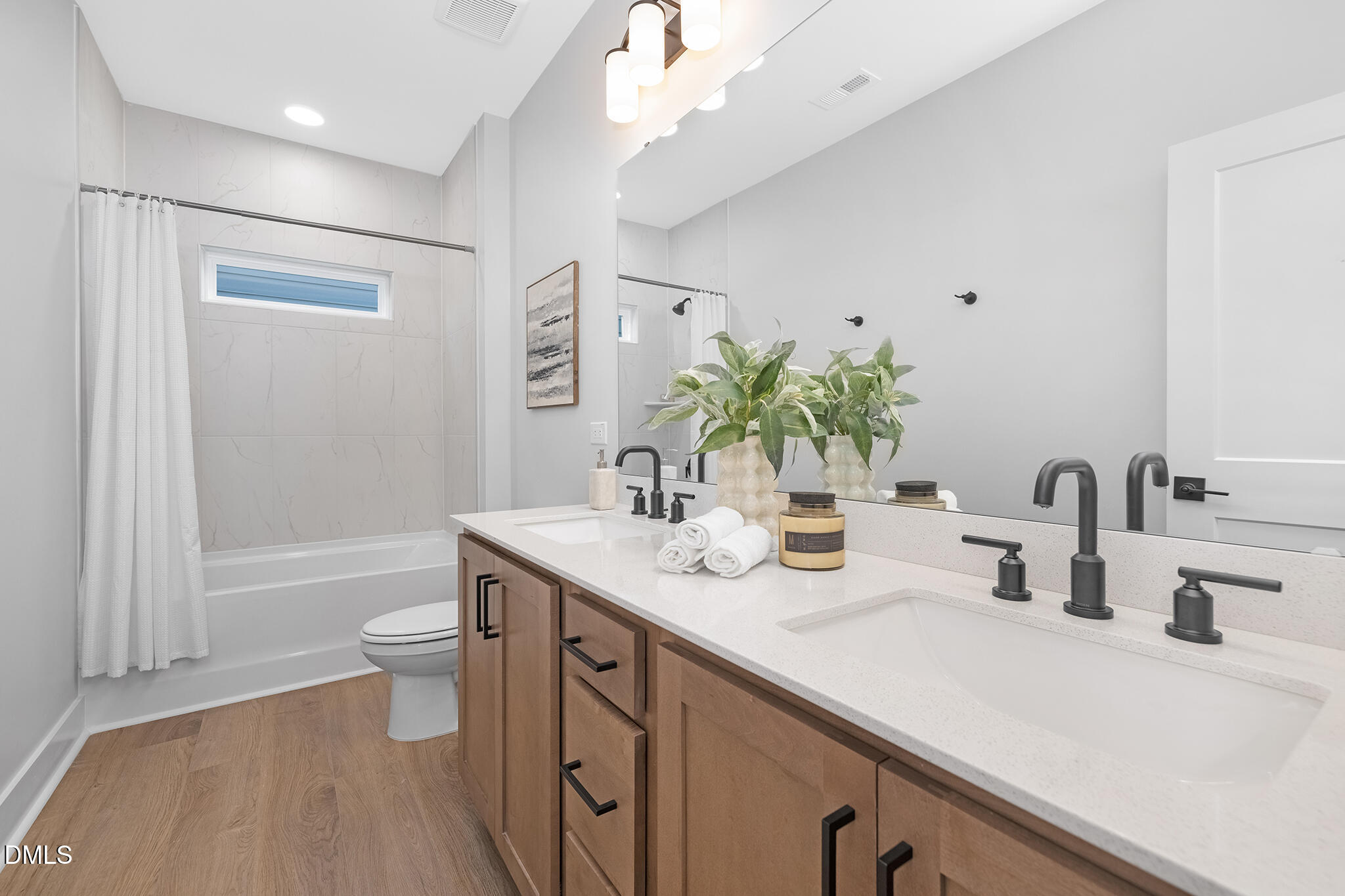 2412 Adrift Road Fuquay-Varina, NC 27526 - Photo 11 of 19 a bathroom with a double vanity sink toilet and shower
