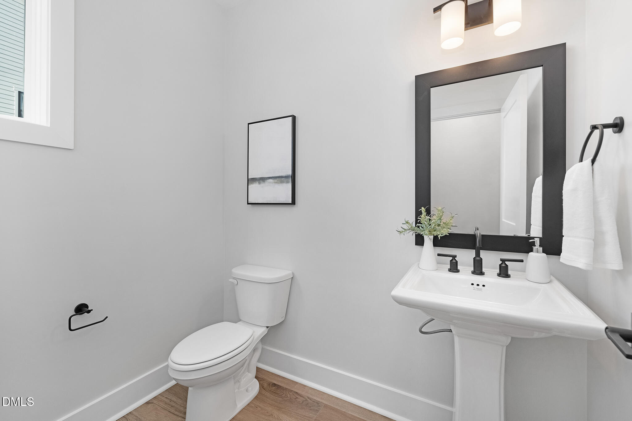 2412 Adrift Road Fuquay-Varina, NC 27526 - Photo 15 of 19 a bathroom with a toilet sink and mirror