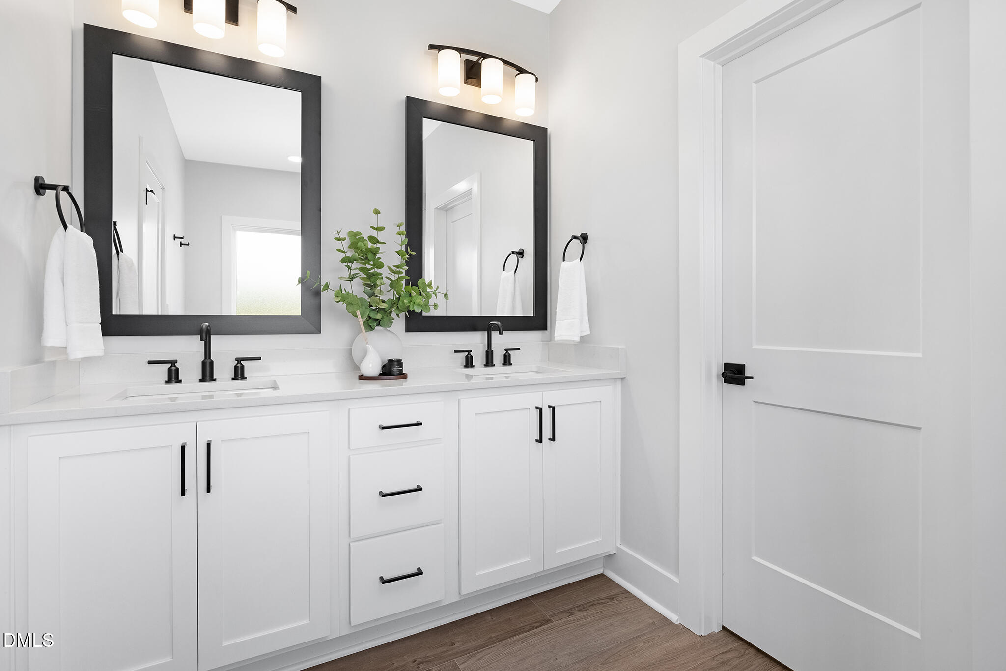 2412 Adrift Road Fuquay-Varina, NC 27526 - Photo 8 of 19 a bathroom with double sink and a mirror