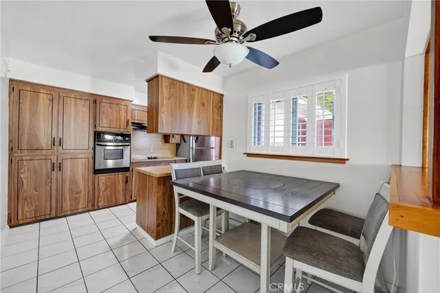 a kitchen with stainless steel appliances granite countertop a stove a sink dishwasher and a refrigerator