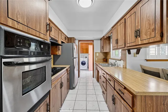 a kitchen with stainless steel appliances granite countertop a stove and a sink