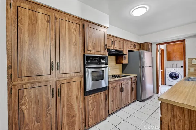 a kitchen with cabinets and stainless steel appliances