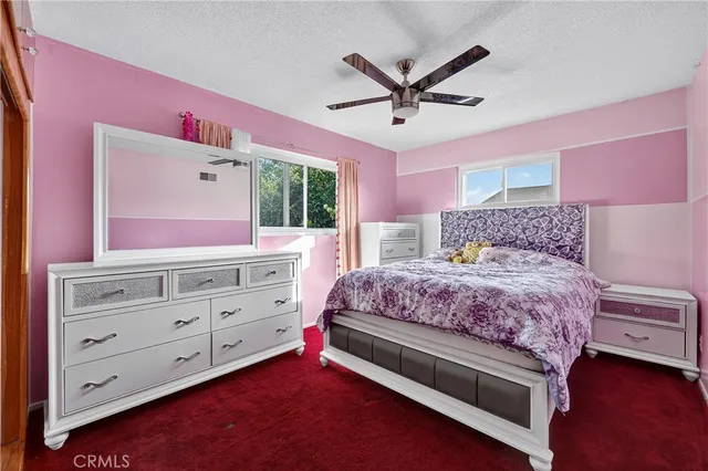 a bedroom with a large bed and a dresser