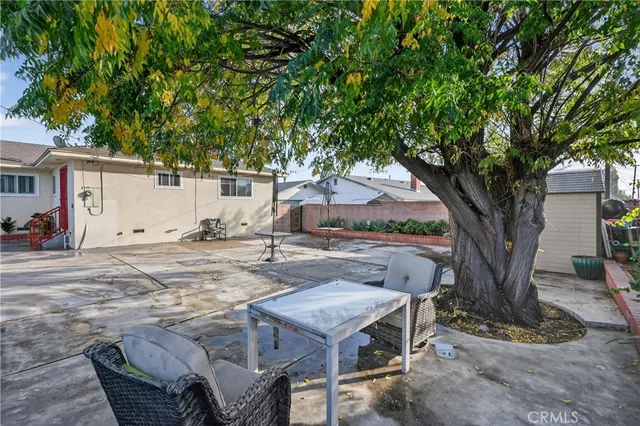 a backyard of a house with table and chairs