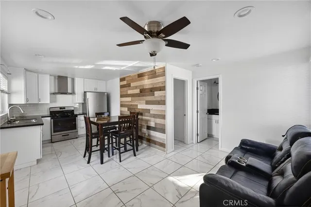a kitchen with granite countertop cabinets and refrigerator