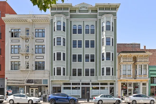 a front view of a residential apartment building with a lot of windows