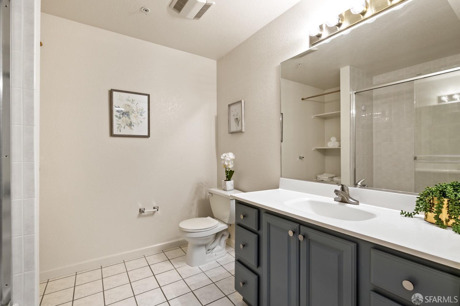485 8th Street, Unit 402 Oakland, CA 94607 - Photo 9 of 16 a bathroom with a sink and a mirror