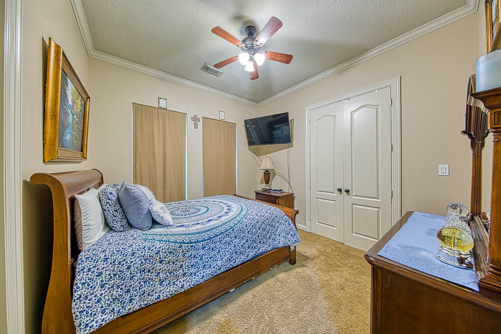 6310 Hamman Street, Unit D Houston, TX 77007 - Photo 29 of 41 a bedroom with a bed and dresser with mirror
