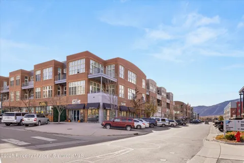a city street with cars parked in front of it