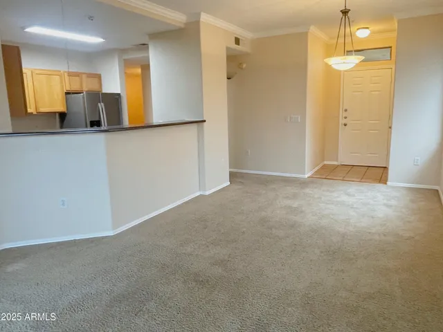 a view of a kitchen with a refrigerator and a sink
