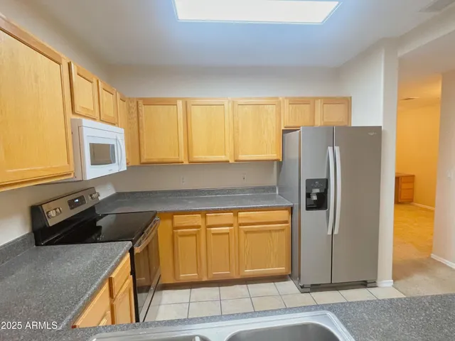 a kitchen with a refrigerator a stove and a cabinets