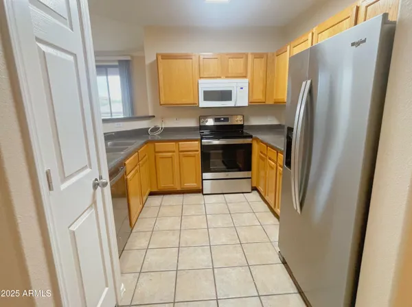a kitchen with stainless steel appliances a refrigerator and a sink