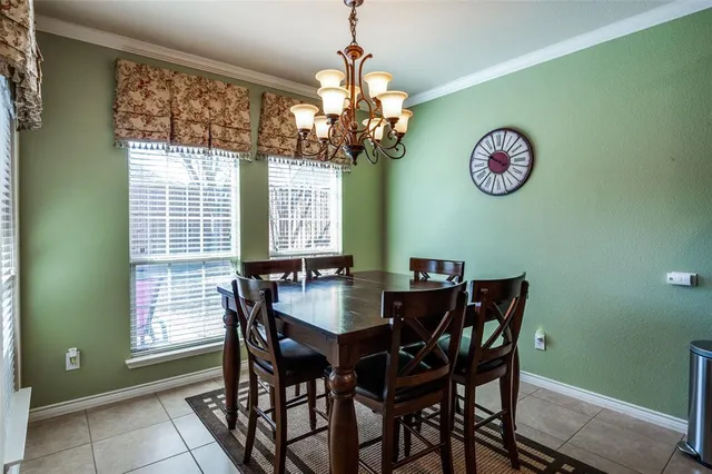 a view of a dining room with furniture and a chandelier