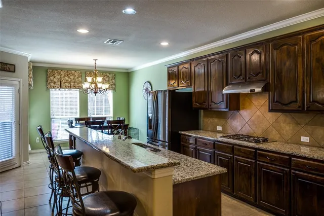 a kitchen with granite countertop lots of counter top space and stainless steel appliances