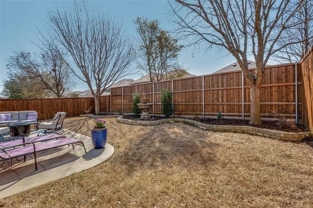 a backyard of a house with barbeque oven and outdoor seating