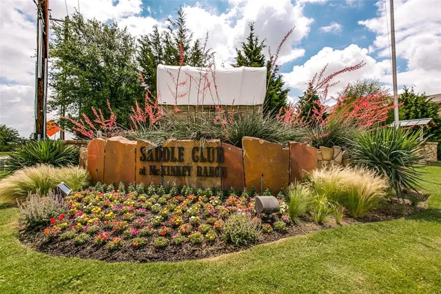 a street sign covered with tall trees
