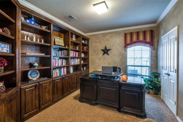 a livingroom with a bookshelf and a workspace
