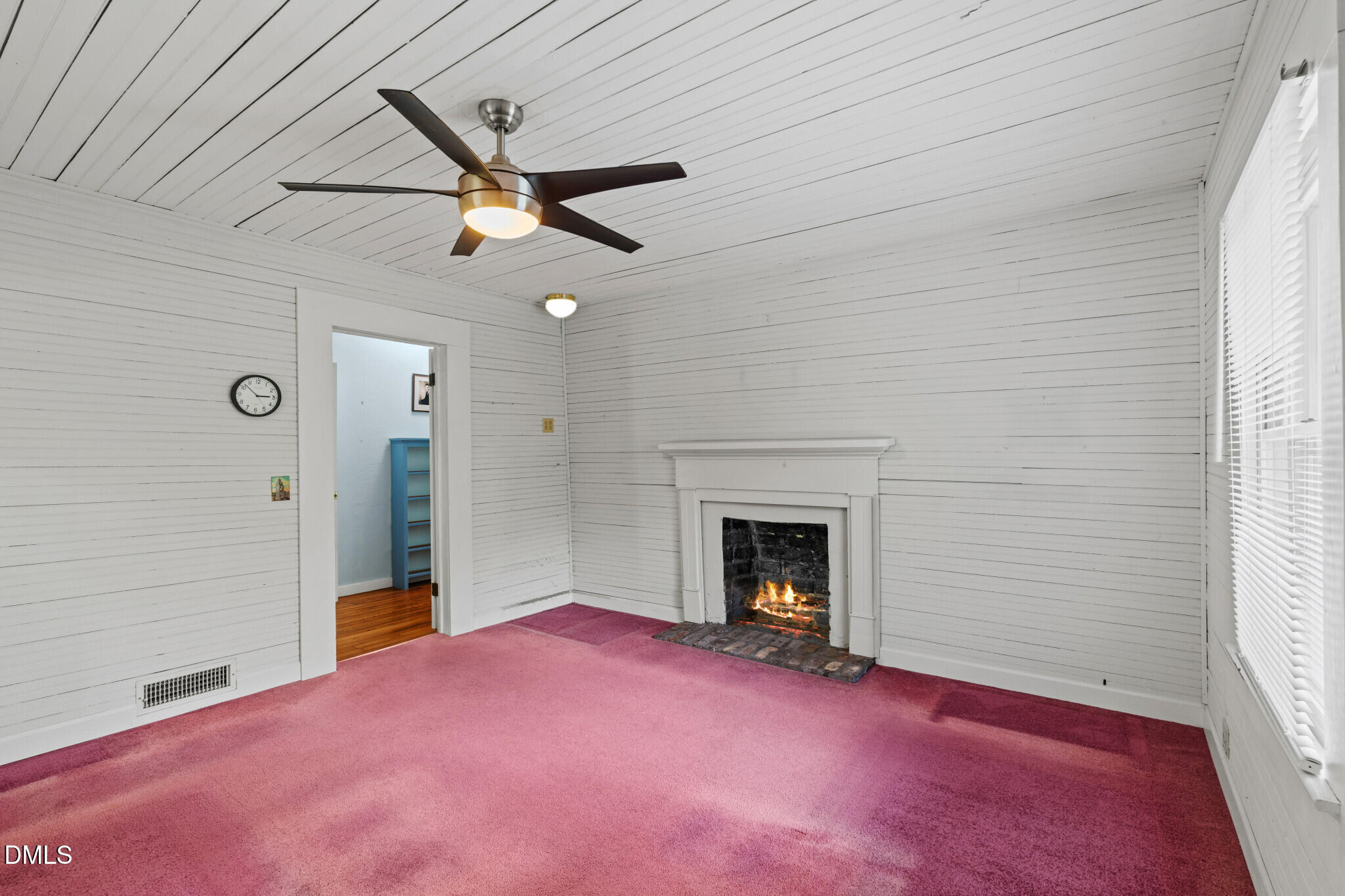 3415 Mt Willing Road Efland, NC 27243 - Photo 19 of 36 a view of empty room with fireplace and fan