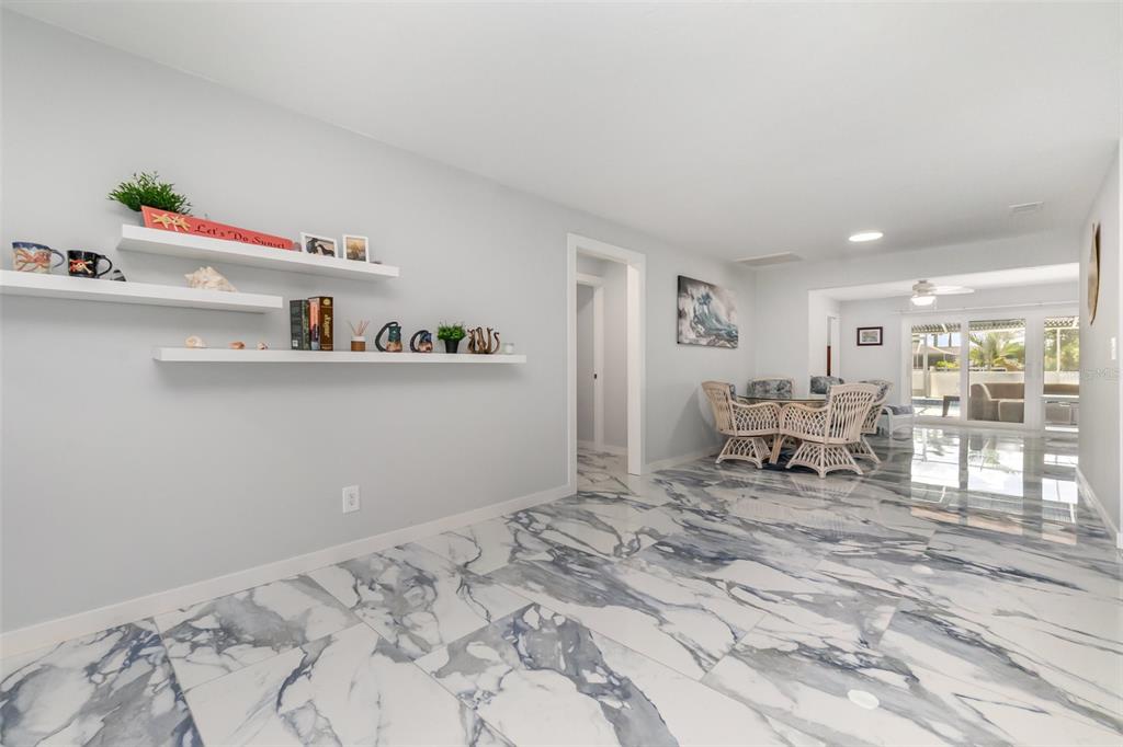 1661 Swan Terrace North Fort Myers, FL 33903 - Photo 11 of 43 a bed room with a bed and a chair