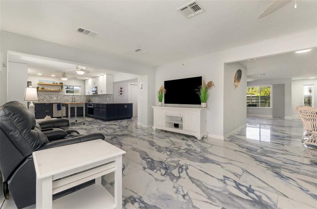 1661 Swan Terrace North Fort Myers, FL 33903 - Photo 12 of 43 a living room with furniture and a flat screen tv