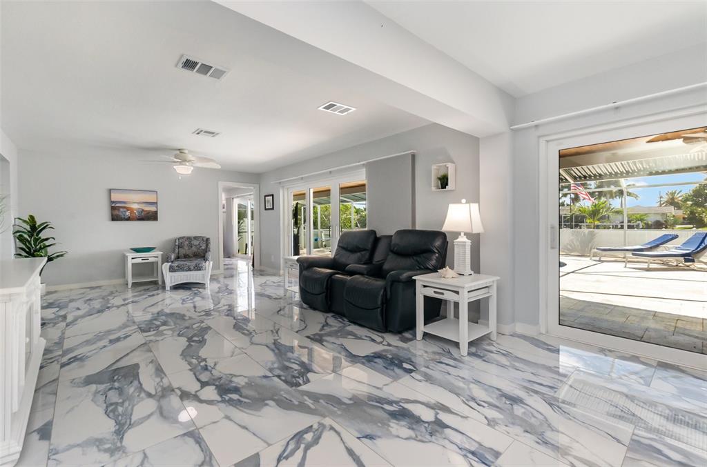 1661 Swan Terrace North Fort Myers, FL 33903 - Photo 14 of 43 a living room with furniture a window and a table