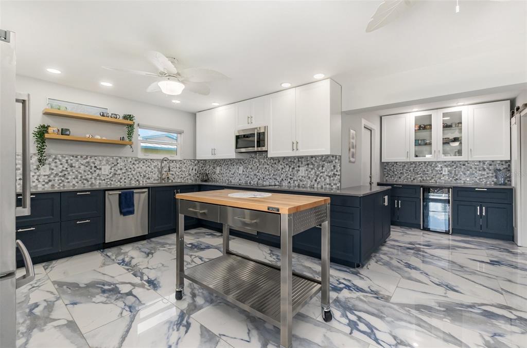 1661 Swan Terrace North Fort Myers, FL 33903 - Photo 18 of 43 a kitchen with granite countertop kitchen island stainless steel appliances a sink stove and cabinets