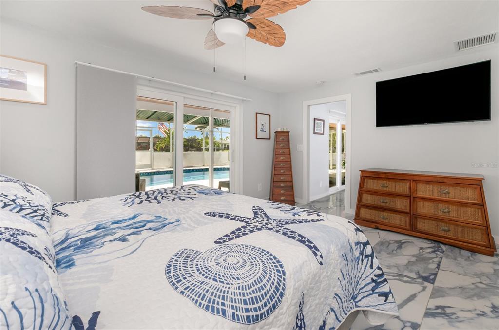 1661 Swan Terrace North Fort Myers, FL 33903 - Photo 22 of 43 a bedroom with a bed and a flat screen tv