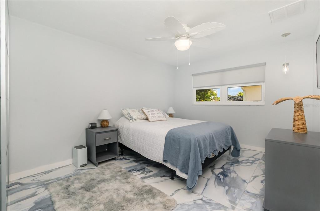 1661 Swan Terrace North Fort Myers, FL 33903 - Photo 25 of 43 a bedroom with a bed and a cabinets