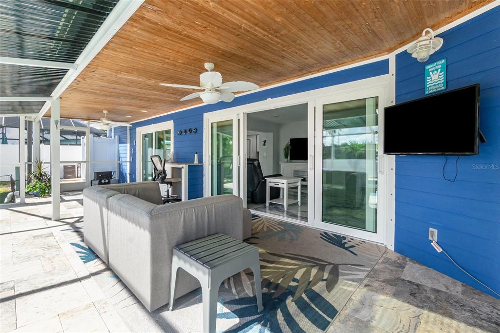 1661 Swan Terrace North Fort Myers, FL 33903 - Photo 33 of 43 a living room with furniture a flat screen tv and a floor to ceiling window