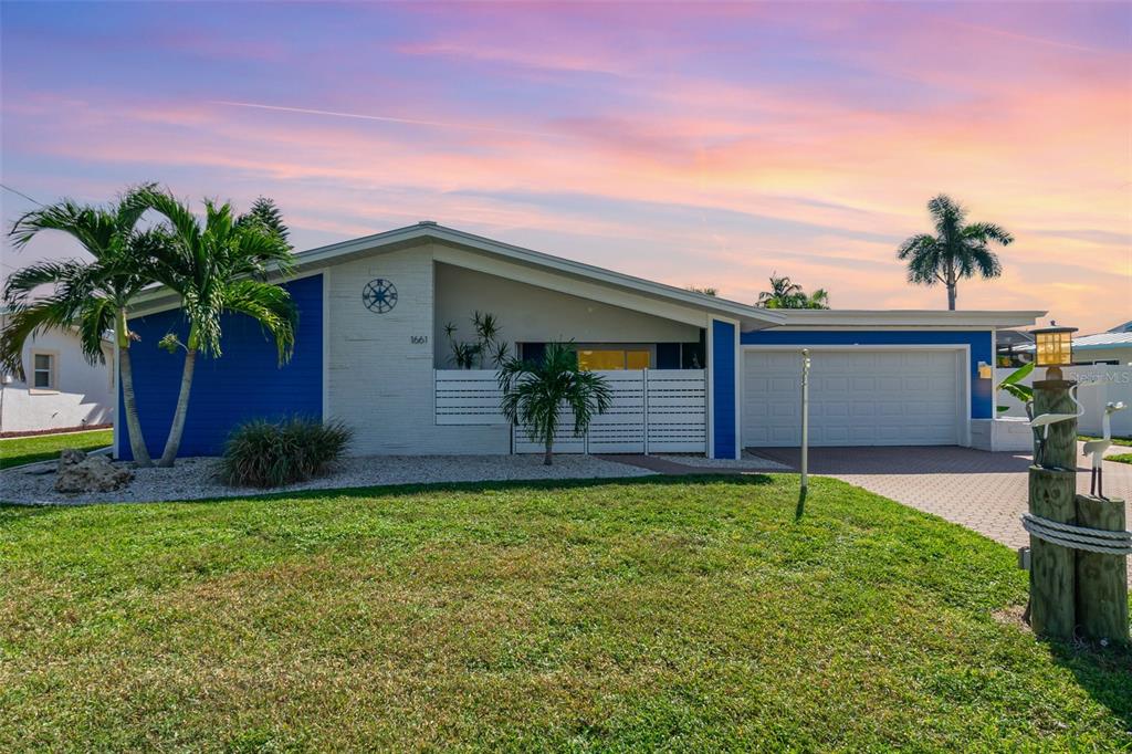 1661 Swan Terrace North Fort Myers, FL 33903 - Photo 43 of 43 a front view of a house with a yard and garage