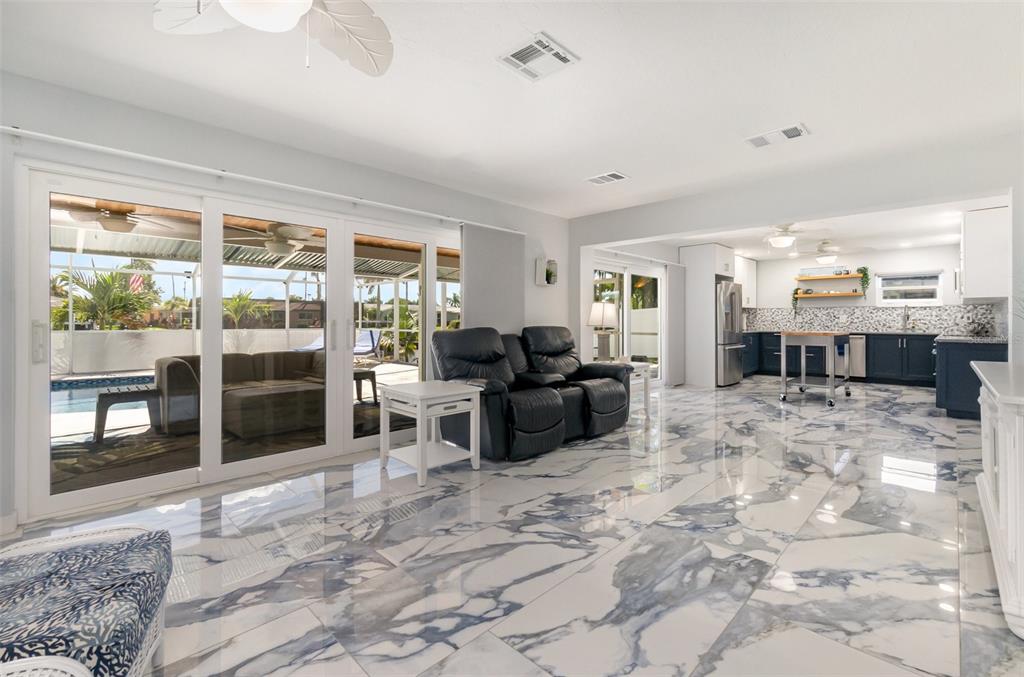 1661 Swan Terrace North Fort Myers, FL 33903 - Photo 5 of 43 a living room with furniture large window and a fireplace