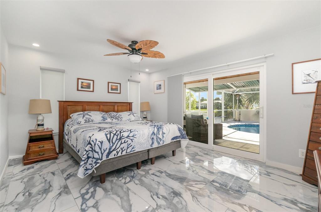 1661 Swan Terrace North Fort Myers, FL 33903 - Photo 6 of 43 a bedroom with a large bed and a window