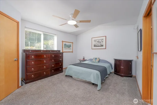 a bedroom with a bed and a dresser
