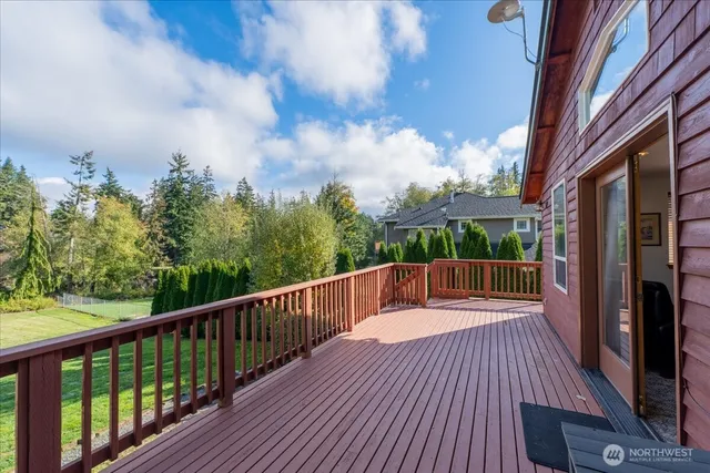 a balcony with wooden floor and city view