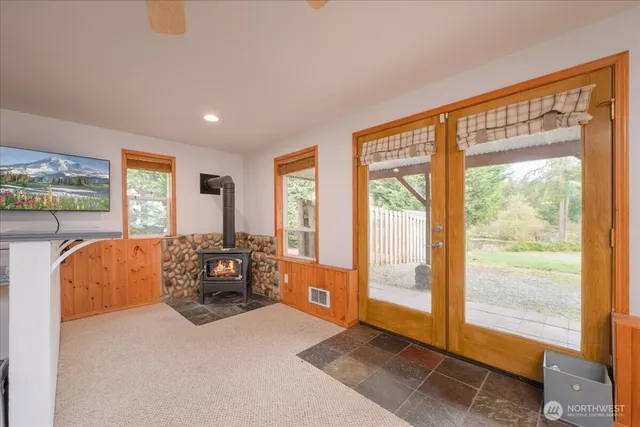 a living room with furniture and a floor to ceiling window