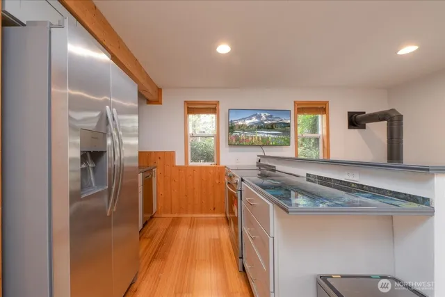 a kitchen with stainless steel appliances granite countertop a stove and a refrigerator