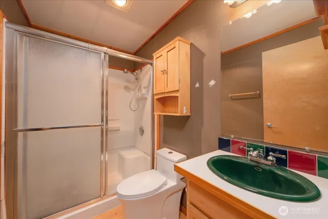 a bathroom with a sink toilet and shower