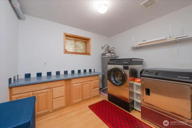 a view of a storage and utility room with washer and dryer